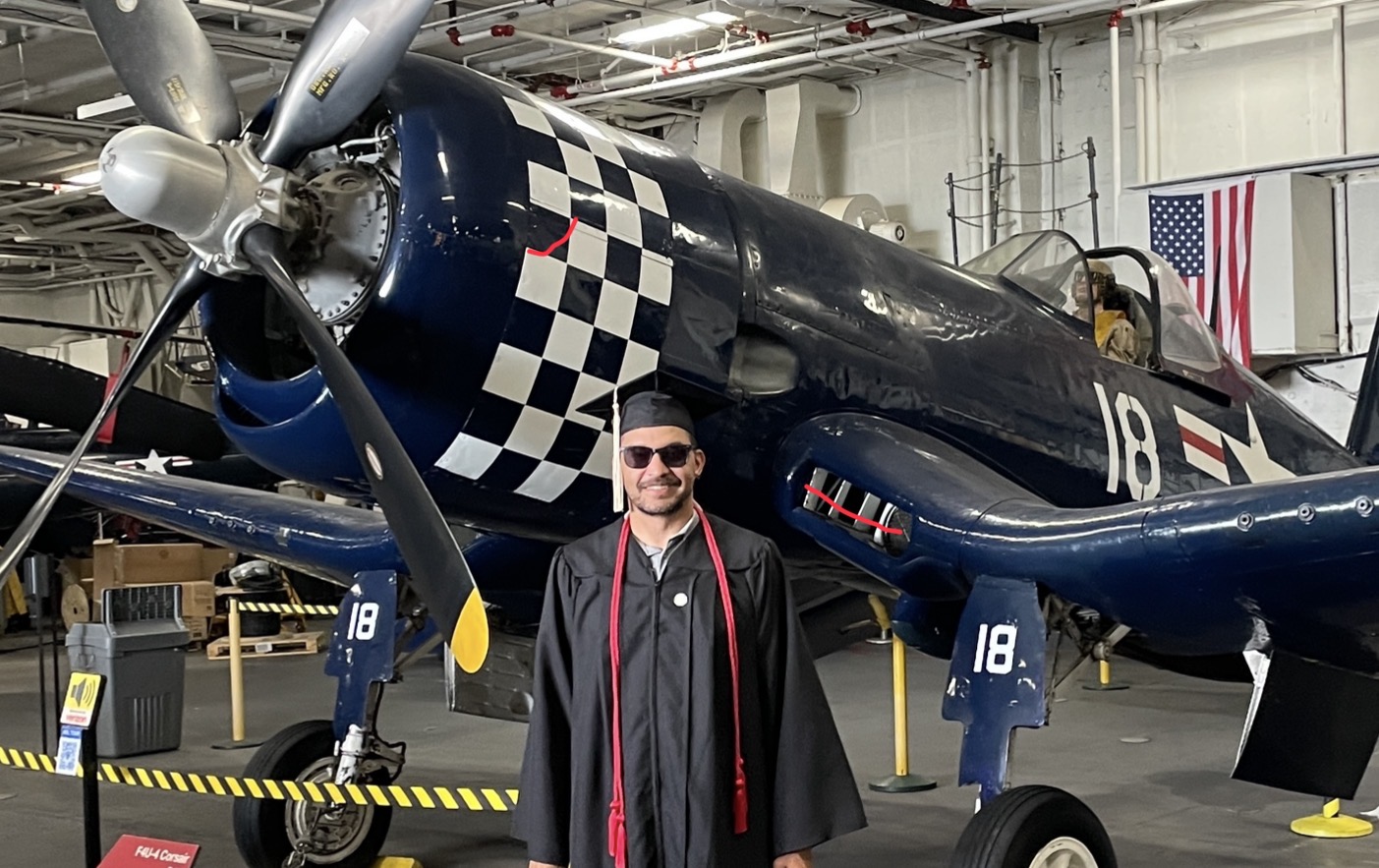 Bryce standing in front of a historic aircraft